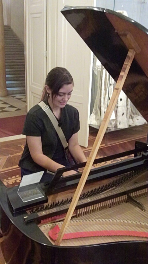 Jenaesha tries out a 19th century piano.