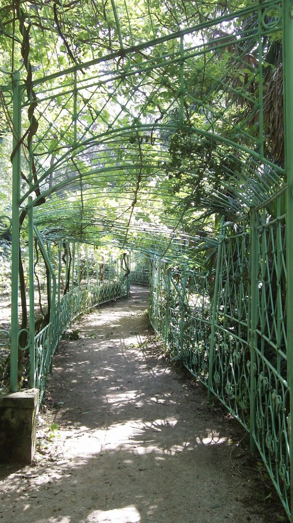 A covered walking path in the park at Miramare.